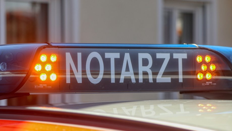 Ein blaues Notarzt-Schild mit orangefarbenen Blinklichtern auf einem Auto.